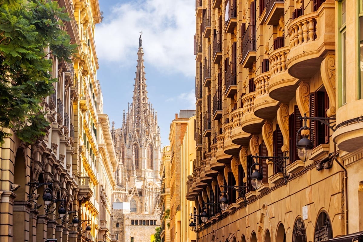 Barcelona's Gothic Quarter with ornate balconies and Sagrada Família visible in the distance