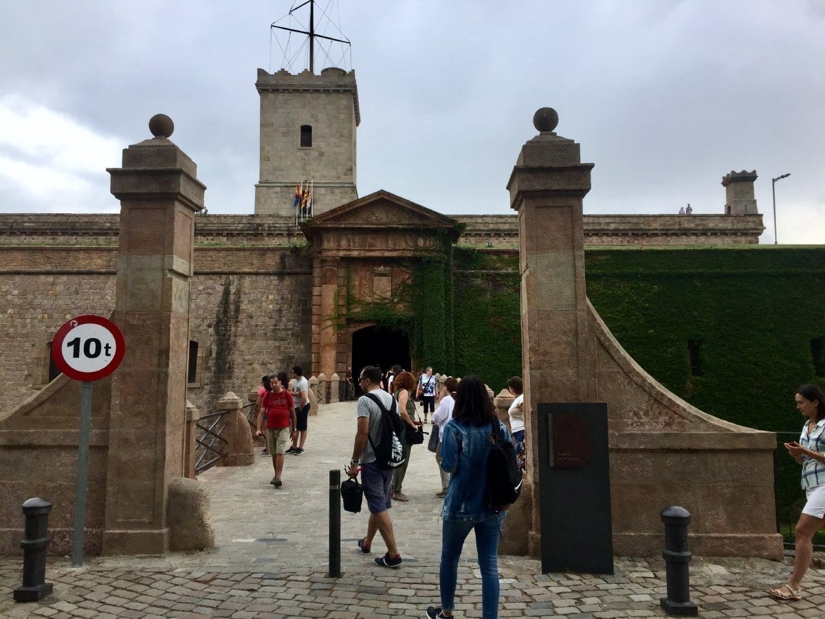Entrance to Castell de Montjuïc with stone walls and walkway