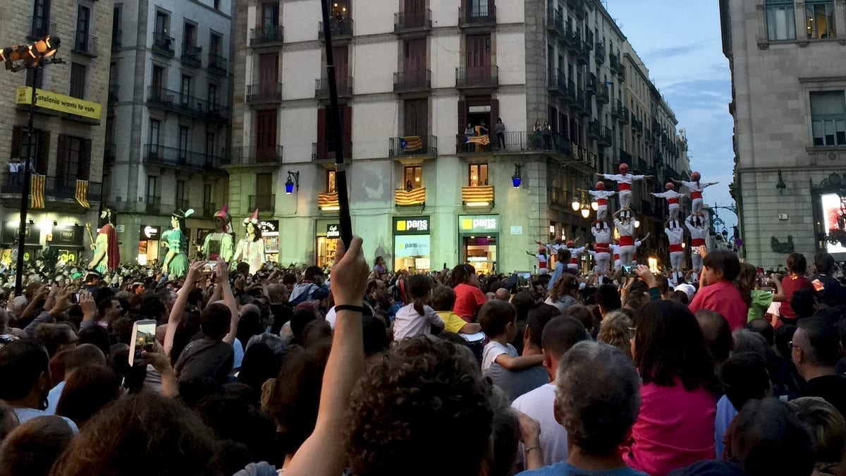 Human pyramid and giant papier-mâché figures during La Mercè festival