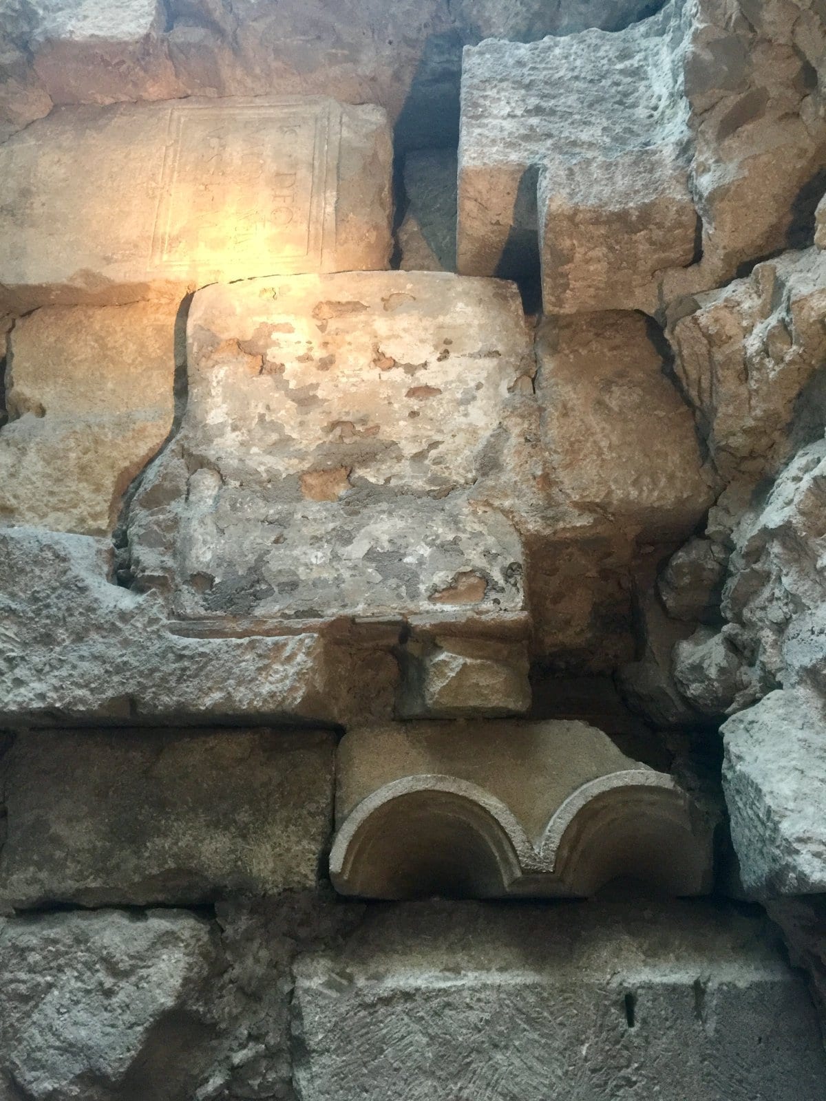 Ancient stone foundations and walls preserved beneath buildings in Barcelona