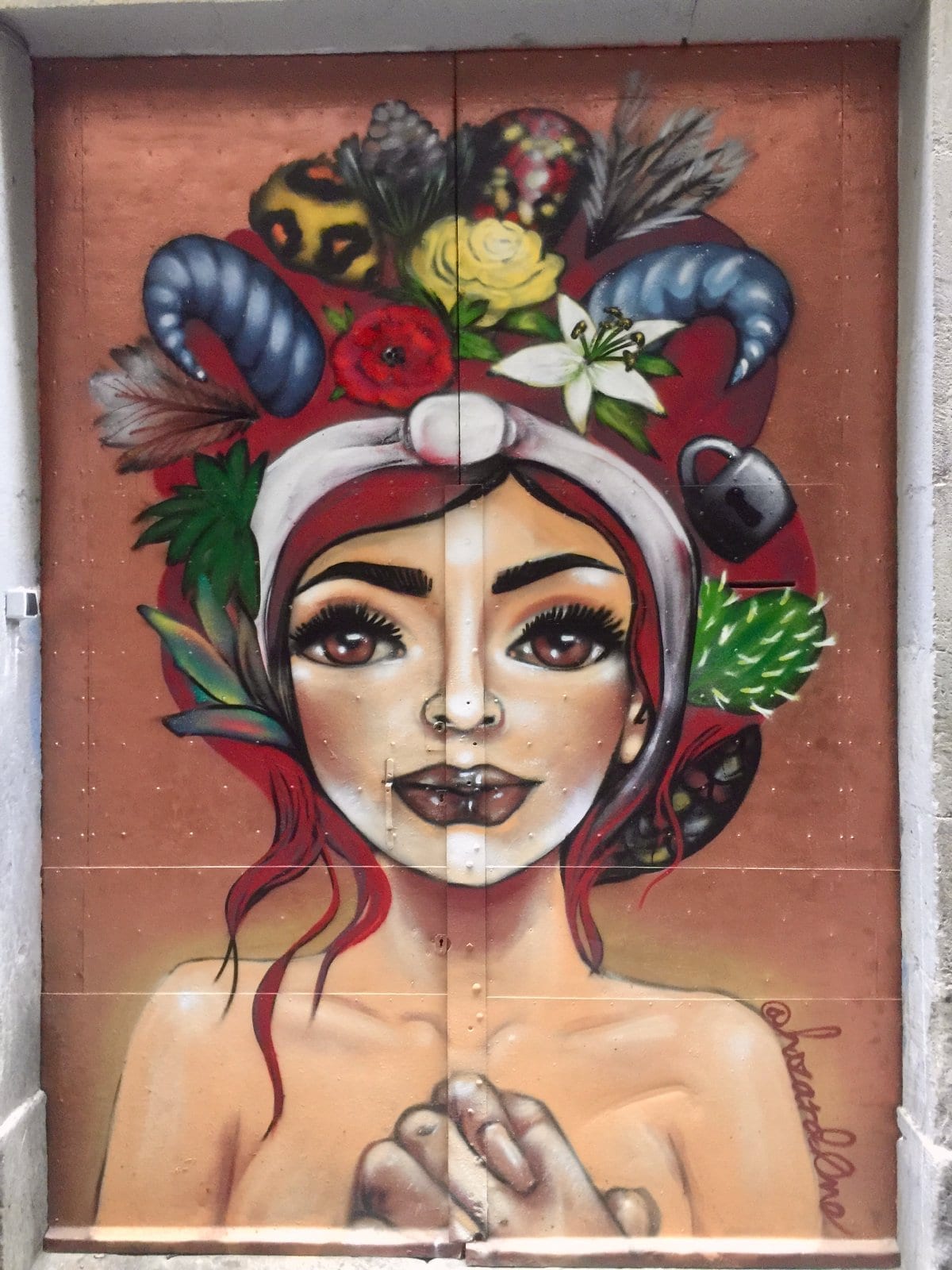 Street art mural of a woman painted on a shop shutter