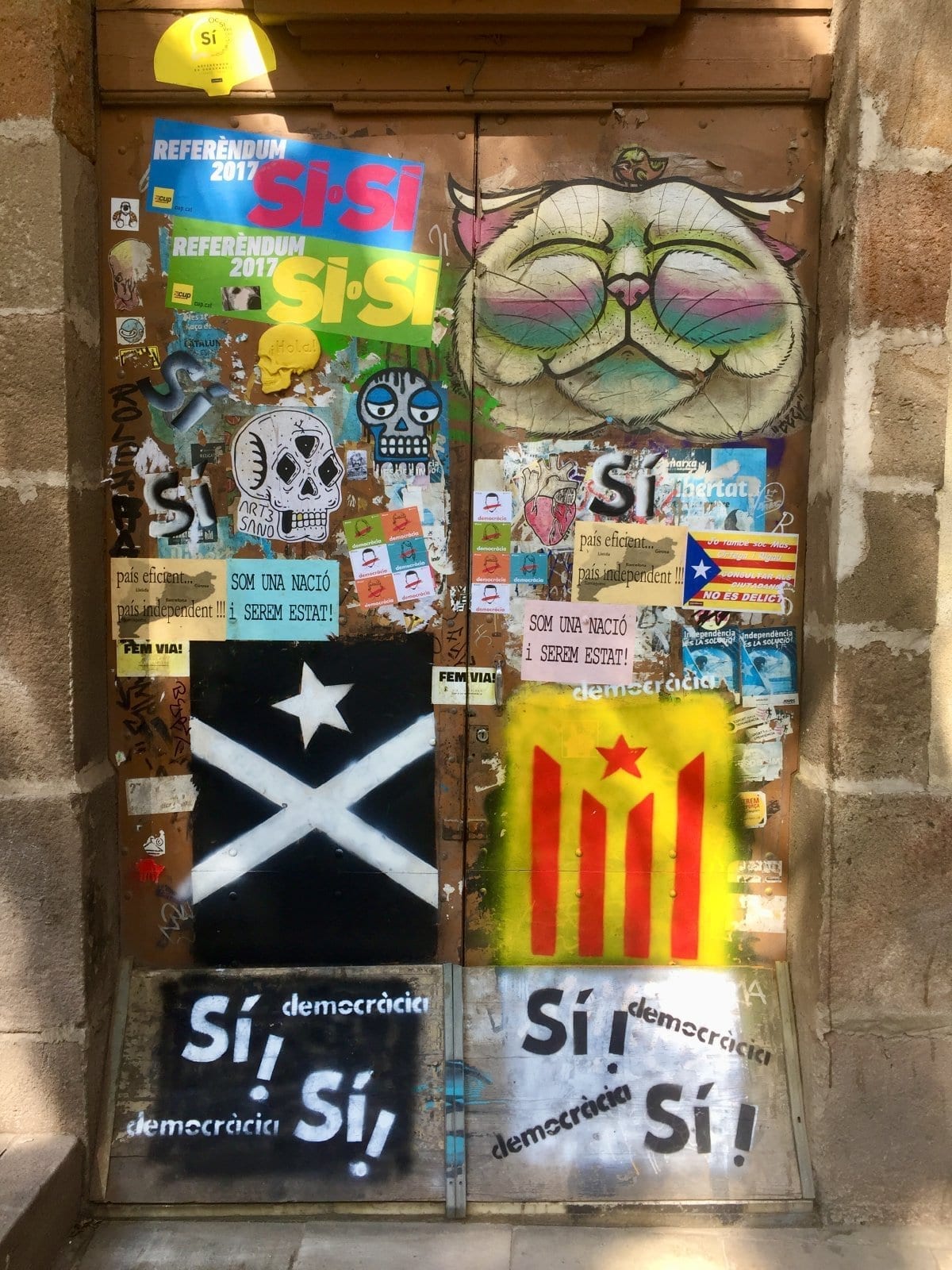 Street posters and stickers covering a wall
