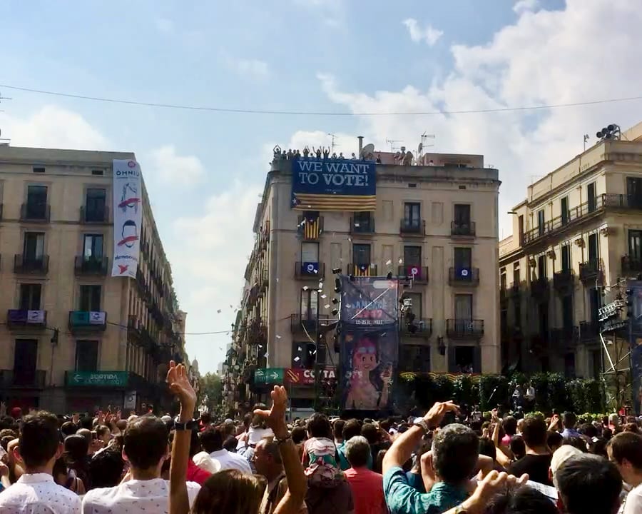 People surround a poster that reads 'We want to vote'